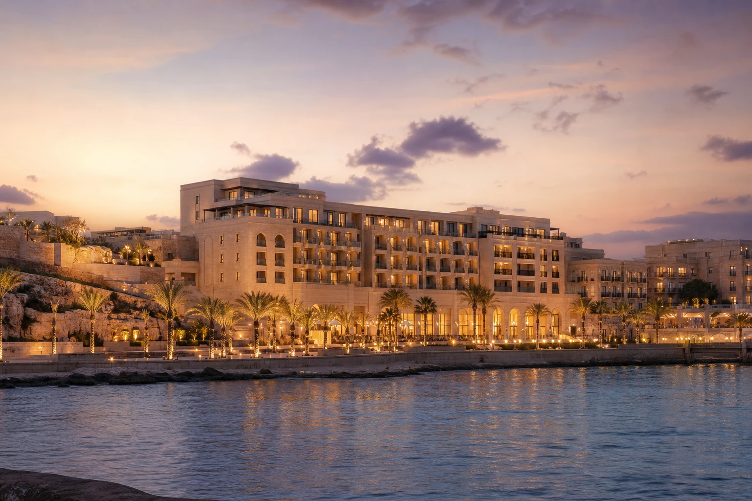 Friday Resort seen from across Spinola Bay at dusk
