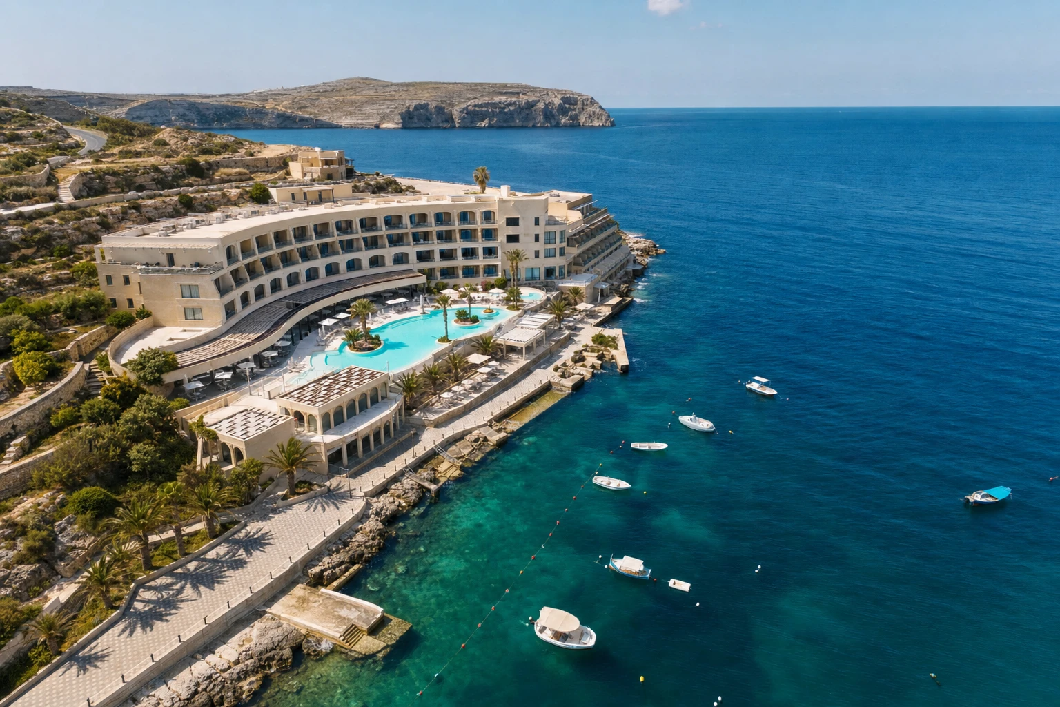 The resort and its pool deck seen from above the bay